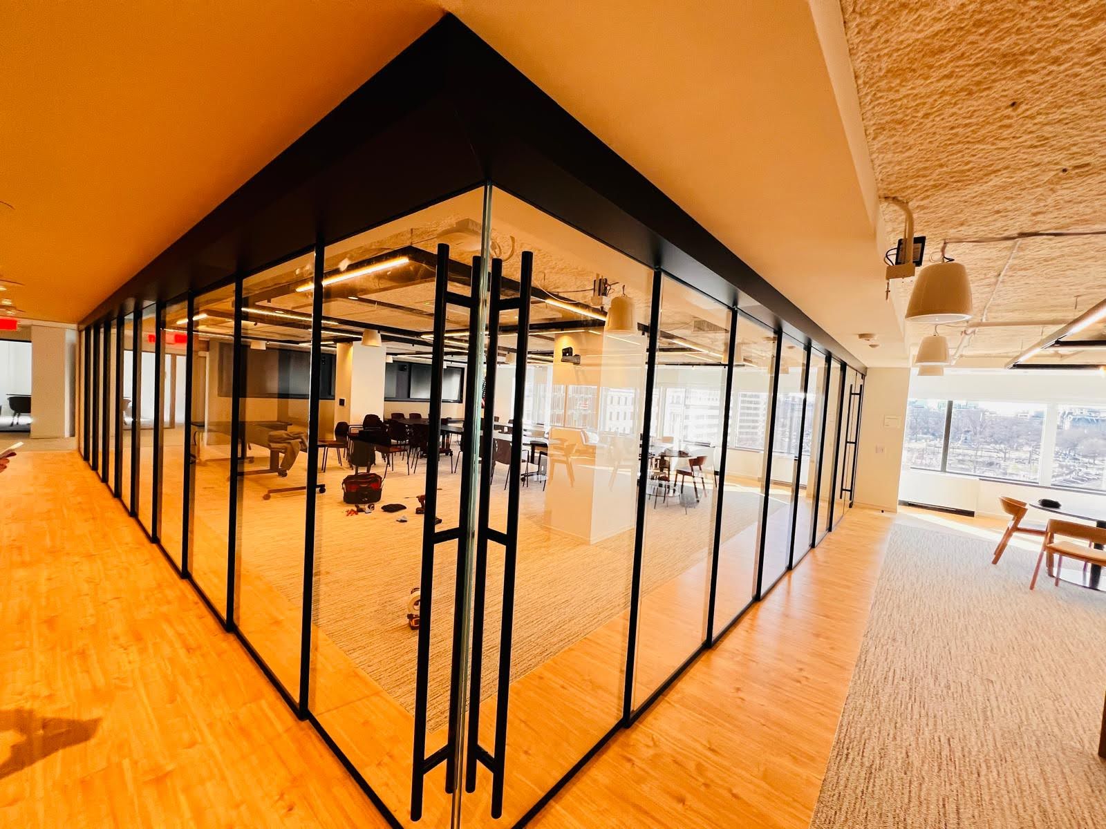 Glass partition installation — open office floor